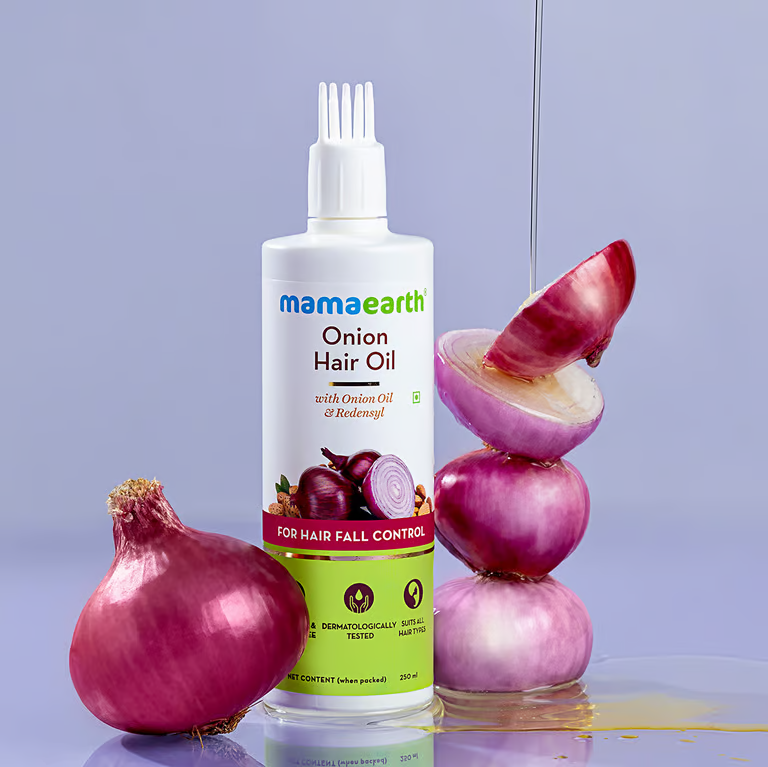 Mamaearth onion hair oil with onion background