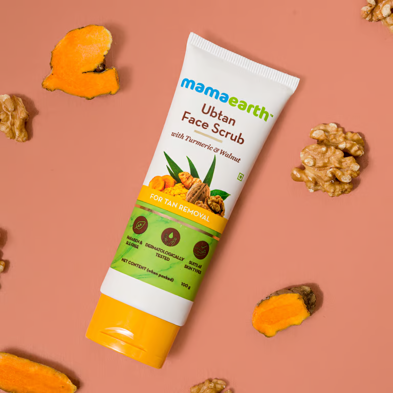 Mamaearth ubtan face scrub with turmeric and walnut background